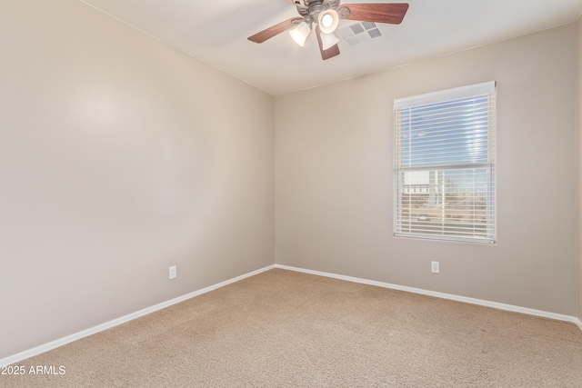 carpeted spare room with ceiling fan