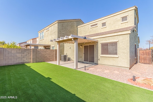 rear view of property with a lawn, a patio, and central air condition unit