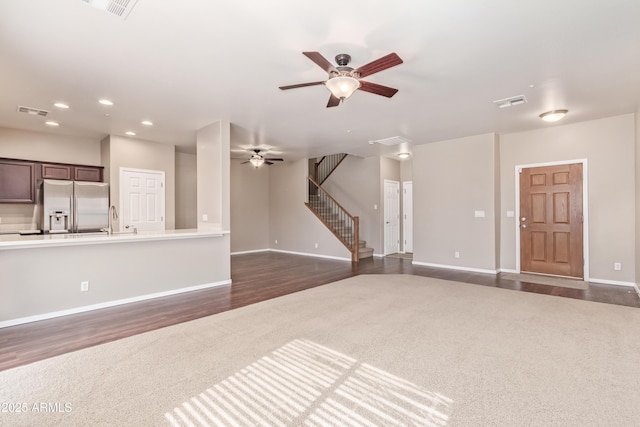 unfurnished living room with sink, dark wood-type flooring, and ceiling fan