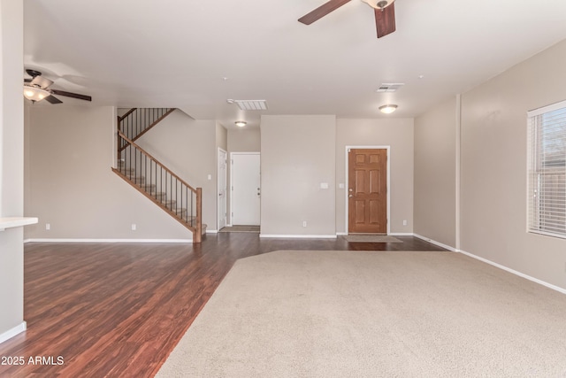 unfurnished living room featuring dark hardwood / wood-style floors and ceiling fan