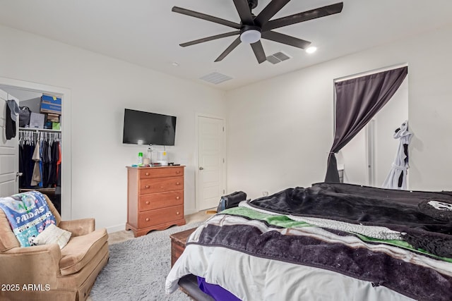 carpeted bedroom featuring ceiling fan and a closet