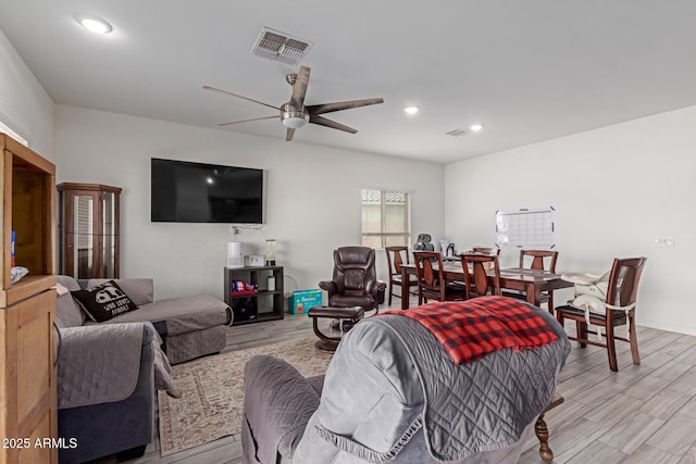 living room with ceiling fan and light hardwood / wood-style floors