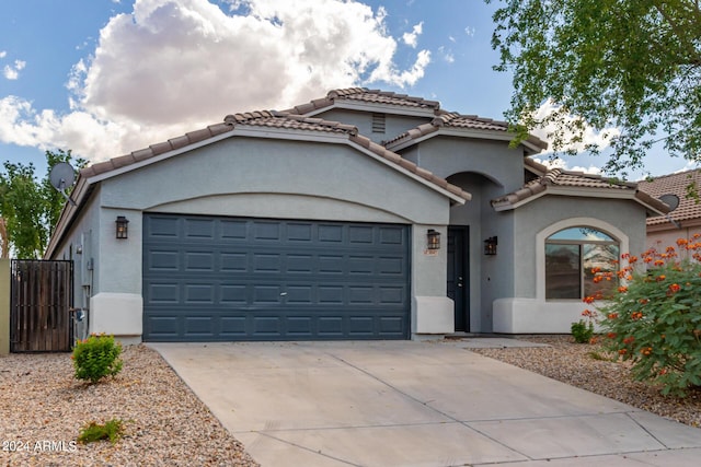 3847 W Yellow Peak Dr, San Tan Valley, AZ 85144 - mediterranean / spanish-style house featuring stucco siding, a tiled roof, driveway, and a garage