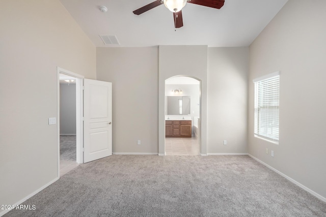 3847 W Yellow Peak Dr, San Tan Valley, AZ 85144 - unfurnished bedroom with visible vents, baseboards, light carpet, ensuite bathroom, and arched walkways
