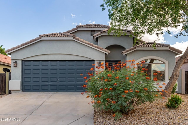 3847 W Yellow Peak Dr, San Tan Valley, AZ 85144 - mediterranean / spanish home with stucco siding, a tiled roof, concrete driveway, and a garage