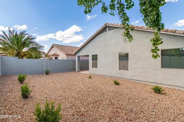 3847 W Yellow Peak Dr, San Tan Valley, AZ 85144 - back of property featuring a tile roof, a fenced backyard, and stucco siding