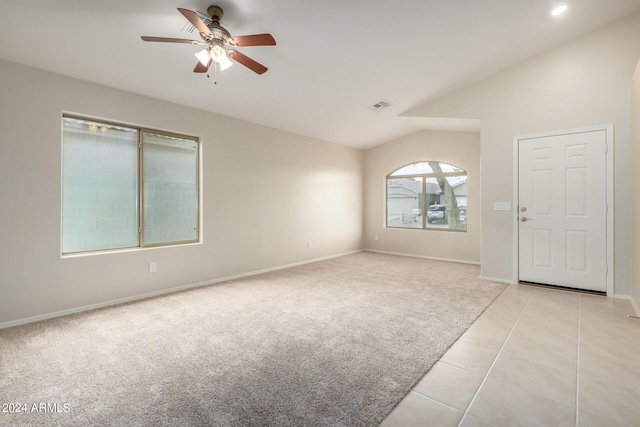3847 W Yellow Peak Dr, San Tan Valley, AZ 85144 - unfurnished room with light tile patterned floors, a ceiling fan, visible vents, lofted ceiling, and light colored carpet