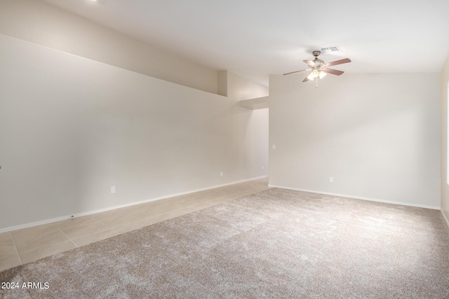 3847 W Yellow Peak Dr, San Tan Valley, AZ 85144 - empty room with visible vents, light carpet, light tile patterned flooring, ceiling fan, and vaulted ceiling