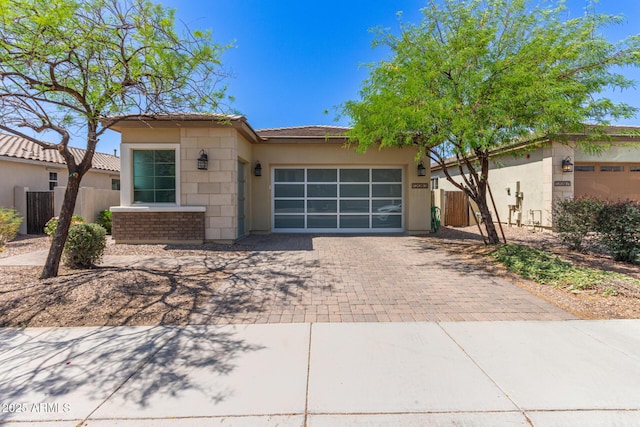 12083 W Peak View Rd, Peoria, AZ 85383 - view of front of property with decorative driveway, a garage, stucco siding, and fence