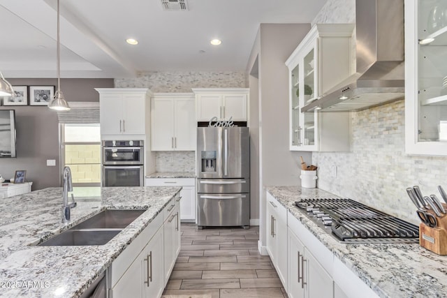 12083 W Peak View Rd, Peoria, AZ 85383 - kitchen featuring stainless steel appliances, a sink, wall chimney range hood, white cabinets, and backsplash