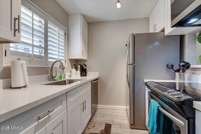 4620 N 68th St Unit 155, Scottsdale, AZ 85251 - kitchen with stainless steel appliances, white cabinetry, and wood tiled floors