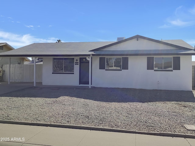 ranch-style house featuring a carport