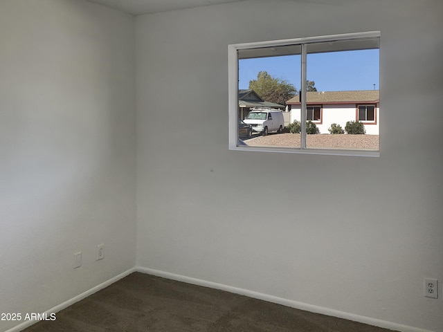 empty room with dark carpet