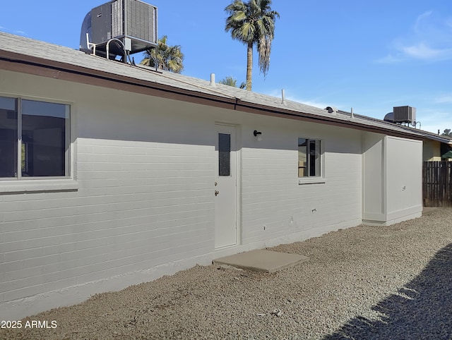 view of side of home featuring central AC