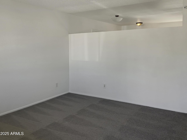 carpeted spare room with a textured ceiling