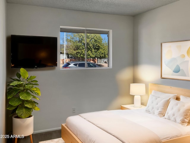 bedroom featuring a textured ceiling and hardwood / wood-style floors