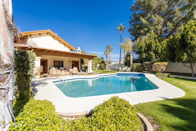 view of pool featuring outdoor lounge area, a yard, and a patio