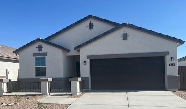 ranch-style house featuring an attached garage, concrete driveway, and stucco siding