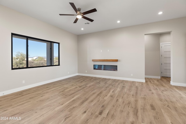 unfurnished living room featuring light hardwood / wood-style floors and ceiling fan