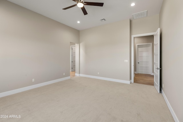 unfurnished bedroom with ceiling fan and light colored carpet