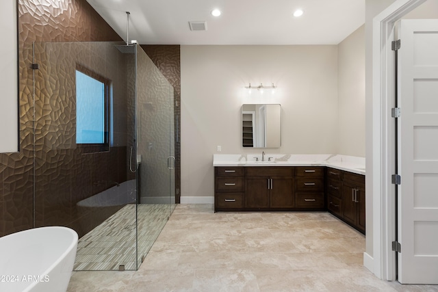 bathroom featuring vanity and separate shower and tub