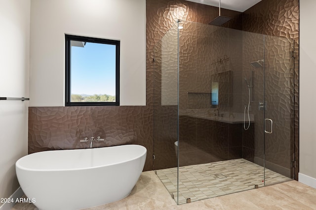 bathroom featuring separate shower and tub