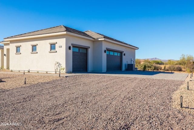 exterior space with a mountain view and central AC unit