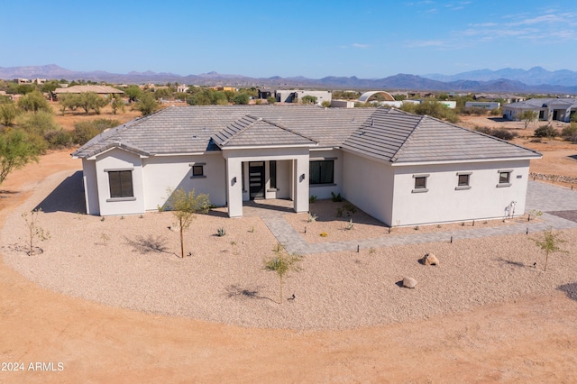 back of property with a mountain view