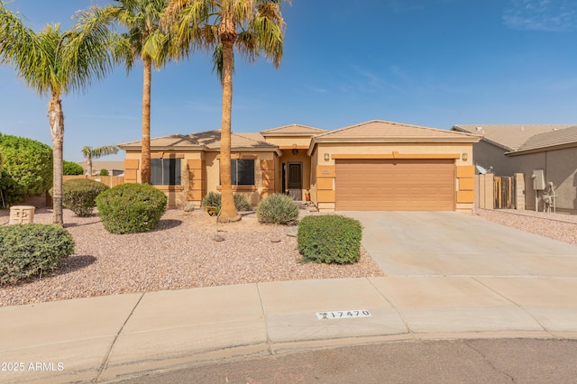 view of front of home featuring driveway, an attached garage, and stucco siding