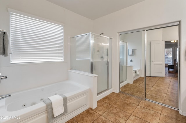 bathroom featuring tile patterned flooring, a shower stall, and a whirlpool tub