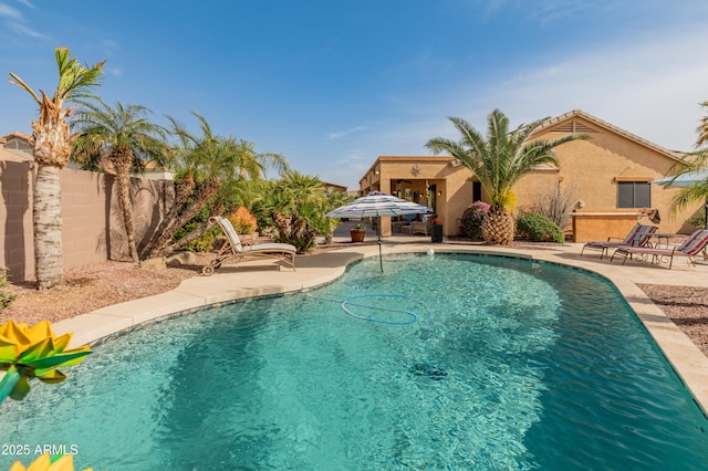 view of swimming pool featuring a patio area, fence, and a fenced in pool