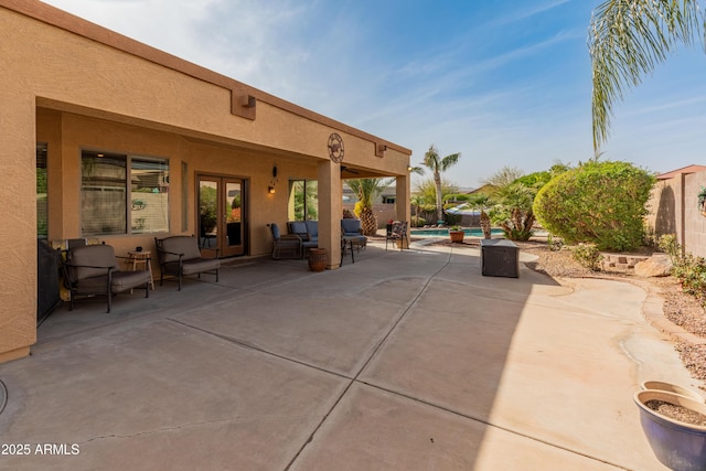 view of patio / terrace with a fenced in pool and french doors