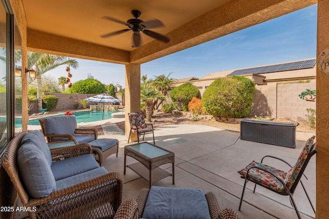 view of patio with a fenced backyard, ceiling fan, a fenced in pool, and an outdoor living space