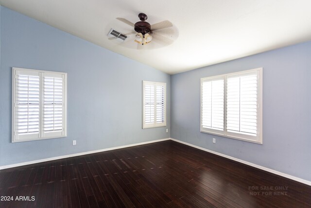 spare room featuring plenty of natural light, vaulted ceiling, ceiling fan, and hardwood / wood-style flooring