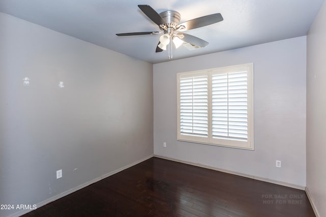 unfurnished room with dark hardwood / wood-style flooring and ceiling fan