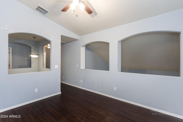 spare room with ceiling fan, lofted ceiling, and dark wood-type flooring