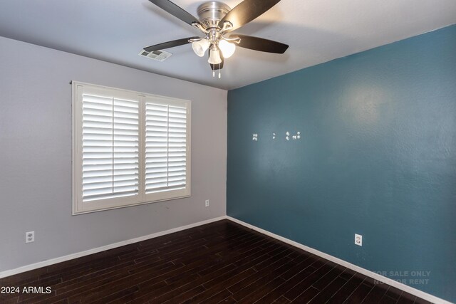 empty room featuring ceiling fan and dark hardwood / wood-style flooring