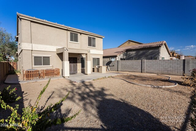 back of property with a patio