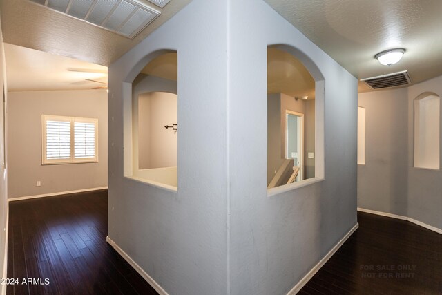 corridor featuring lofted ceiling and dark wood-type flooring