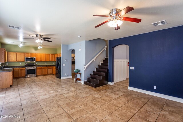 kitchen featuring appliances with stainless steel finishes, sink, and ceiling fan