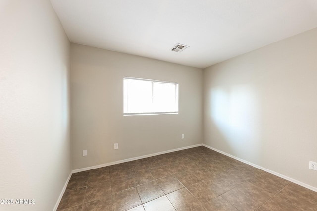 spare room with visible vents and baseboards