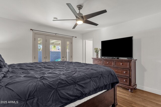 bedroom with access to exterior, ceiling fan, and dark wood-type flooring