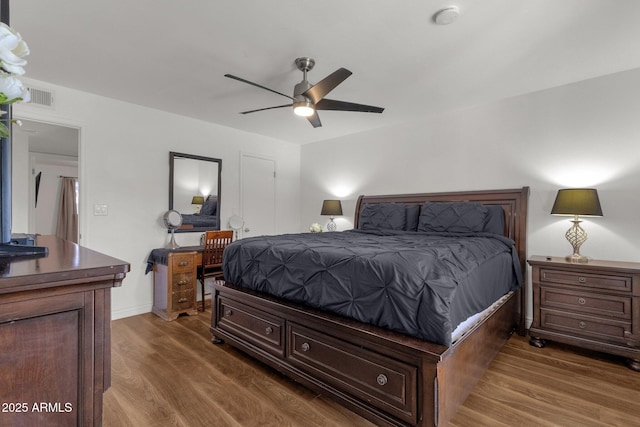 bedroom with ceiling fan and dark hardwood / wood-style floors