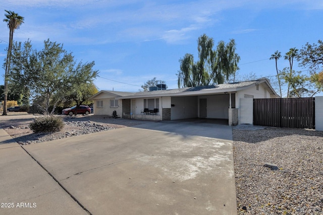 ranch-style home featuring a carport