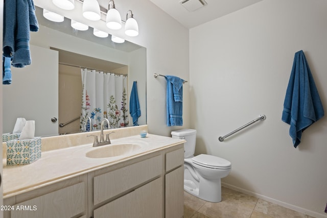 bathroom with tile patterned flooring, vanity, toilet, and walk in shower