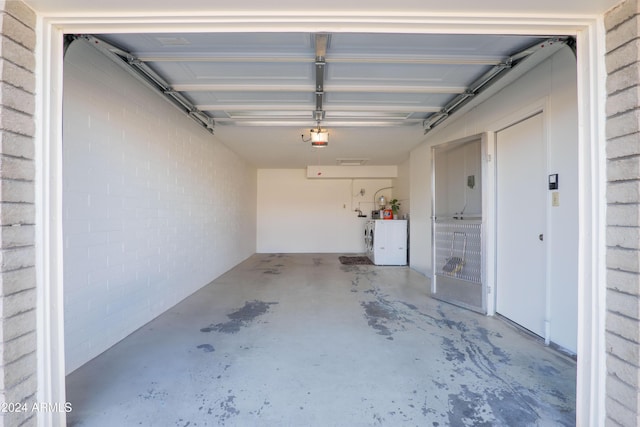 garage with washer and clothes dryer and a garage door opener