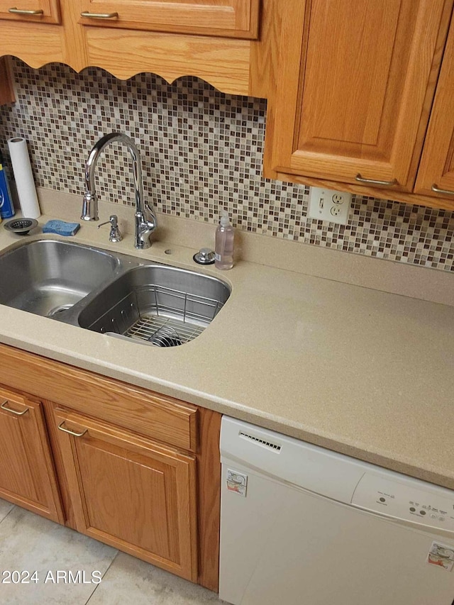 kitchen with backsplash, dishwasher, and sink