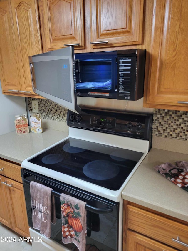 kitchen with white electric range and backsplash