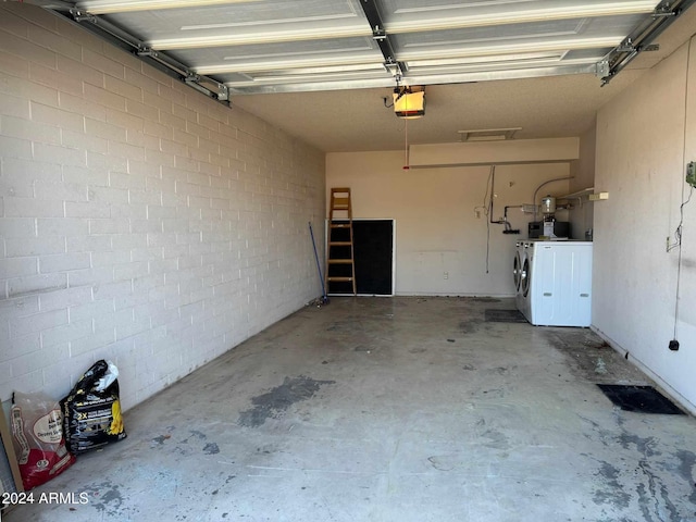 garage with a garage door opener and washing machine and clothes dryer