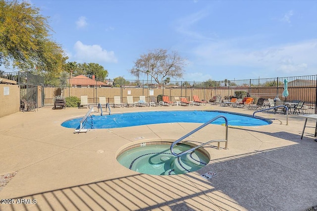 pool featuring a hot tub, fence, and a patio